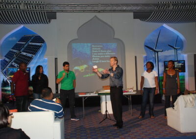tim hall corporate magician performs magic with many adults at abbott laboratories team