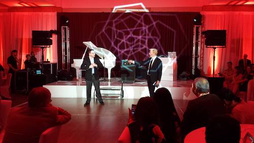 tim hall corporate magician performs with gentleman on stage at corporate party, v3