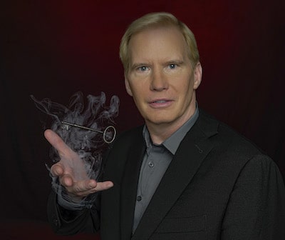 tim-hall-magician-making-key-floating-above-his-hand-smoke-being-produced