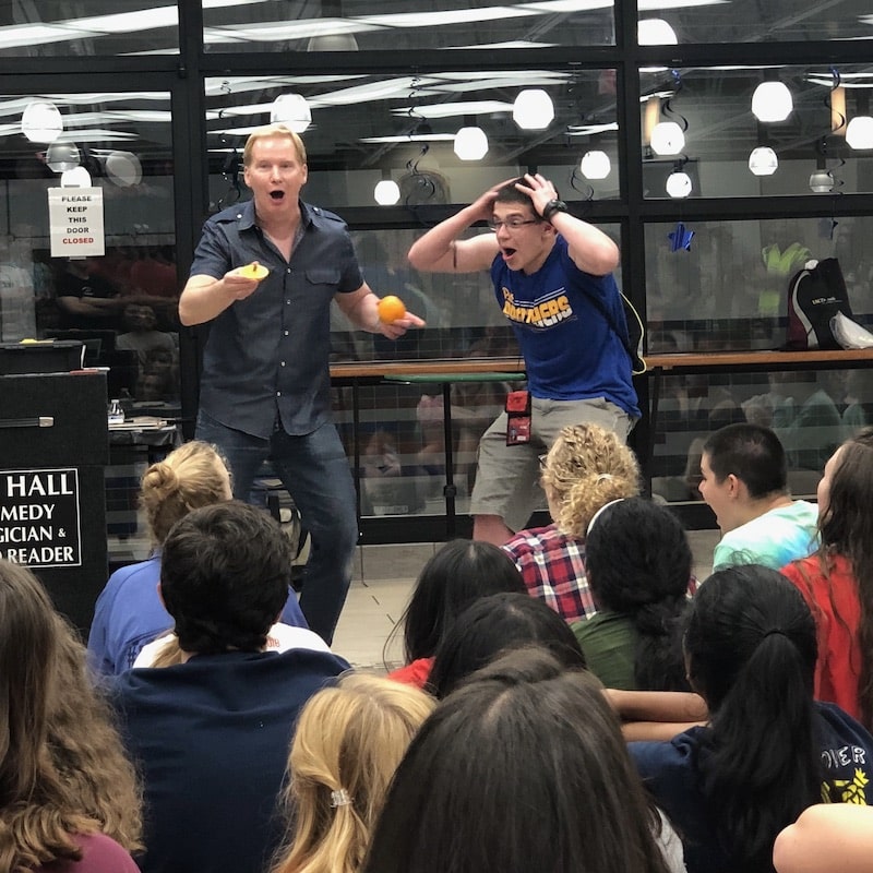 tim-hall-magician-performing-magic-for-large-group-of-teenagers-high-school