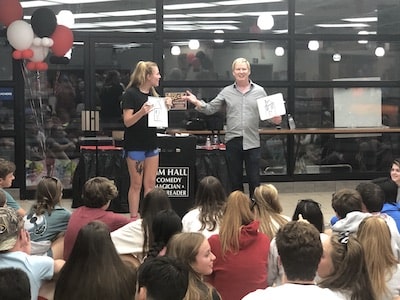 tim-hall-magician-performs-for-large-crowd-high-school-teenagers