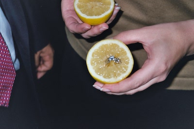 tim_hall_engagement_party_magician_helps_man_propose_to_woman_by_making_the_engagement_ring_magically_appear_inside_a_lemon